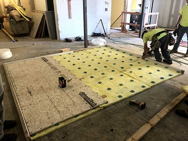 Rollout isolation floor system for noise and vibration control